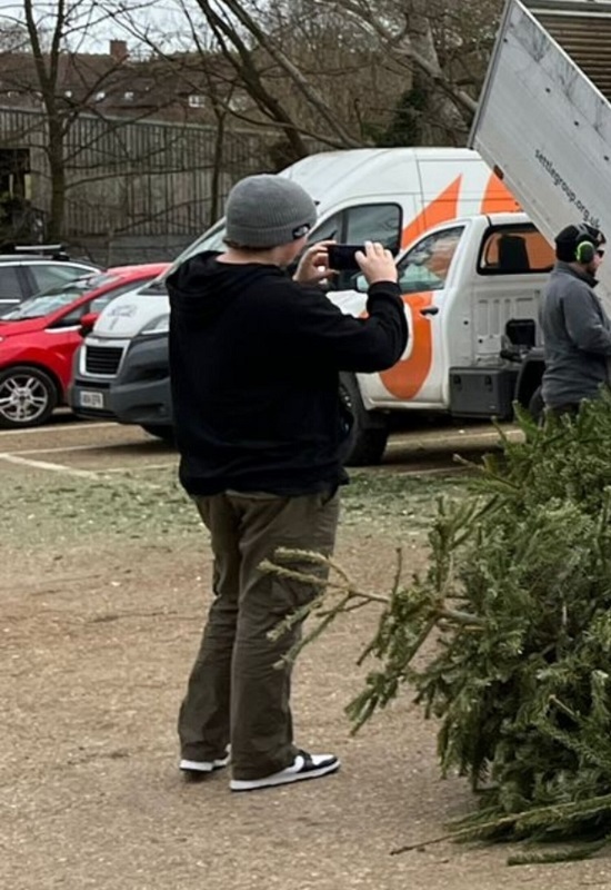 reece-takes-photos-of-christmas-treecycling-volunteers